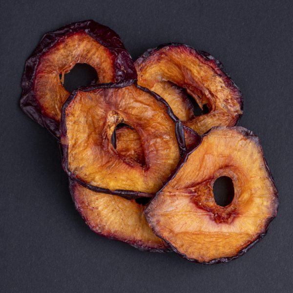top view of dried plum slices isolated on a black background